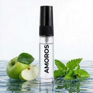 CocoBerry Amoros 5ml tester perfume bottle standing in rippling water alongside a fresh green apple, an apple slice, and crisp mint leaves.