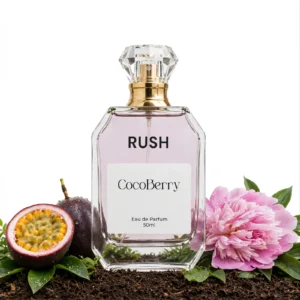 Rush Eau de Parfum 50ml by CocoBerry in a clear glass bottle with a gold spray cap, displayed with fresh passion fruit, pink peony flower, and green leaves – Bombshell Impression Perfume