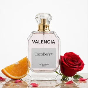 Valencia Eau de Parfum 50ml by CocoBerry in a clear glass bottle with a gold spray cap, displayed with a fresh orange slice, red rose, and rose petals – Coco Chanel Impression Perfume