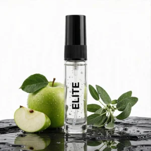 CocoBerry Elite 5ml tester perfume bottle on wet dark stone, paired with a green apple and sage leaves.