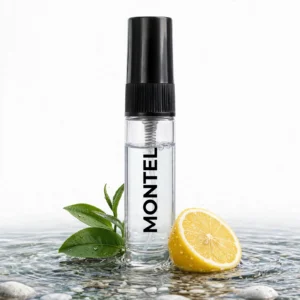 CocoBerry Montel 5ml tester perfume bottle standing in shallow water surrounded by a lemon slice and green tea leaves.