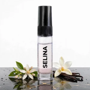 CocoBerry Selina 5ml tester perfume bottle resting on wet dark marble, featuring vanilla bean pods, a vanilla orchid, and fresh white blossoms.